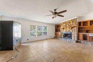 Unfurnished living room featuring ceiling fan, a t