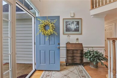 GRACIOUSLY APPOINTED VAULTED FOYER WITH HARDWOOD F