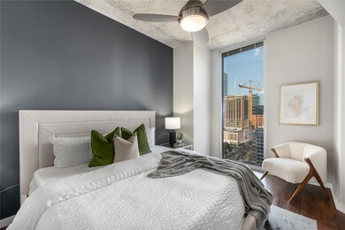 Bedroom with wood finished floors and a ceiling f