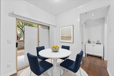 Dining area featuring dark wood-style floors, bas