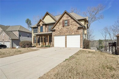 View of front facade with stone siding, a porch, c