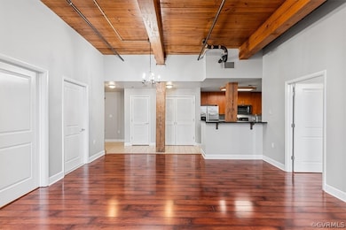 Unfurnished living room with dark hardwood / wood-