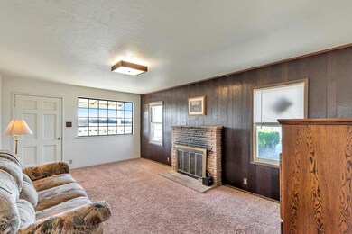 Living room with wood burning fireplace.