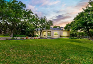 Back of house at dusk with a yard