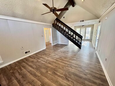 Unfurnished living room with hardwood / wood-style