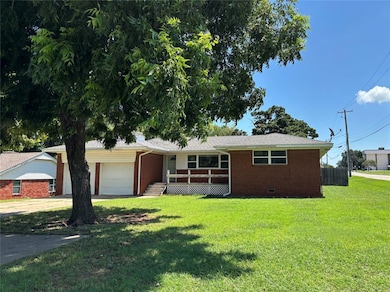 Ranch-style house with brick siding, a garage, and a front lawn