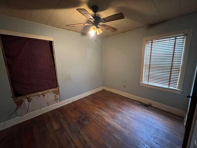 Empty room with ceiling fan and dark hardwood / wo
