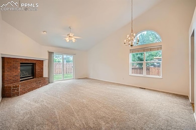 Large living room with a beautiful brick gas log fireplace, mantle and hearth.