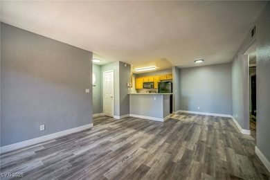 Unfurnished living room with dark wood-style floor