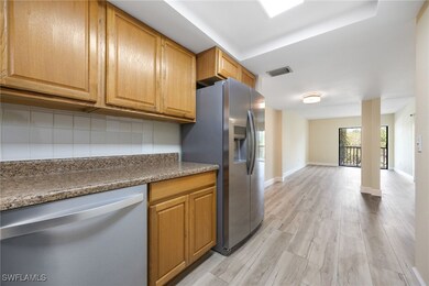 Kitchen with stainless steel fridge, tasteful back