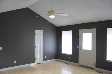 Vaulted ceilings in the living room. everything from walls to doors and trim has been painted with soothing color.
