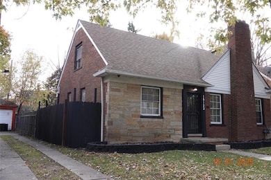 View of front of home featuring roof with shingles, a chimney, brick siding, and stone siding