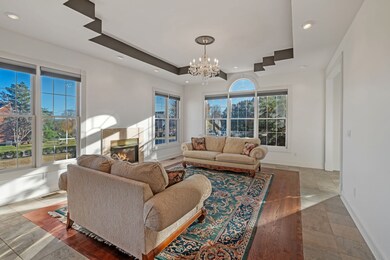 The formal living room is filled with natural light. The opening on the right is to the foyer.