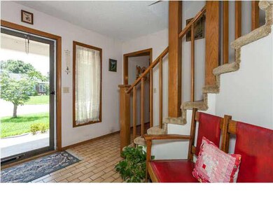 Spacious entry with carpet saving tile flooring.