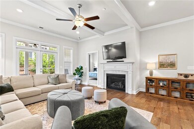 Living area featuring ceiling fan, wood finished f