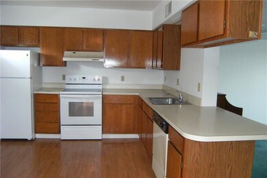 Kitchen With New Laminate Floor and Newer Stove An