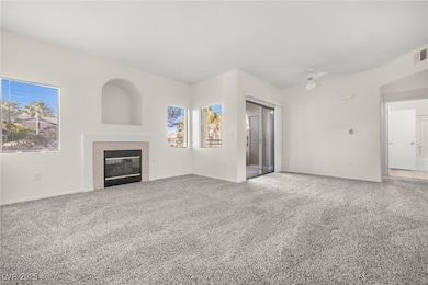 Unfurnished living room with a tile fireplace, car