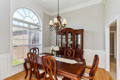Notice these beautiful windows with the arched glass in this Formal Dining Room. The home has been repainted completely in this light and bright Agreeable Gray!