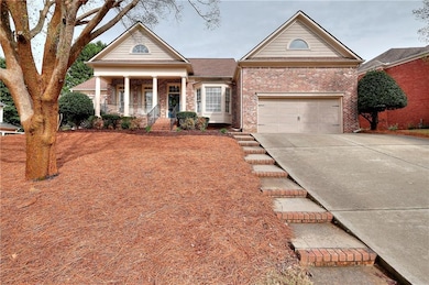 Greek revival house with driveway, brick siding, a