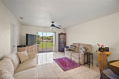 Living room with light tile patterned flooring and