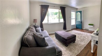 Living room feels so inviting with large window, a