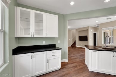 Kitchen featuring visible vents, white cabinets, g