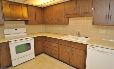 The roomy kitchen with ample cabinets & counter sp