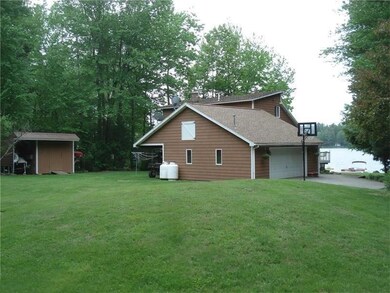 view of lawn, garage and the lake too