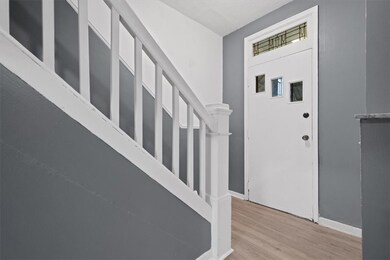 original stained glass entry and stairs