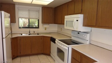 Kitchen; tiled floor, newer range and microwave.
