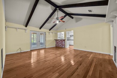 Living room with double doors leading to the huge screened in patio