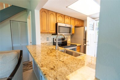 Kitchen with decorative backsplash and appliances
