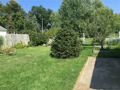 Nice patio next to garage. The yard extends beyond