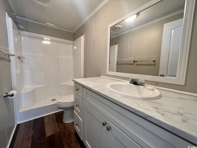 Bathroom featuring vanity, wood-type flooring, wal