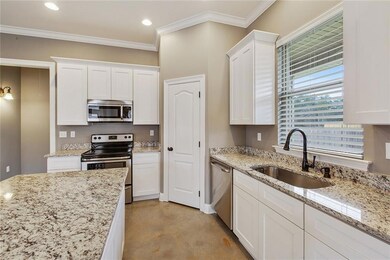 Kitchen has granite, large island with barstool se