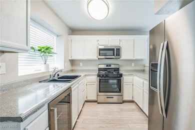 Kitchen featuring stainless steel appliances, wine