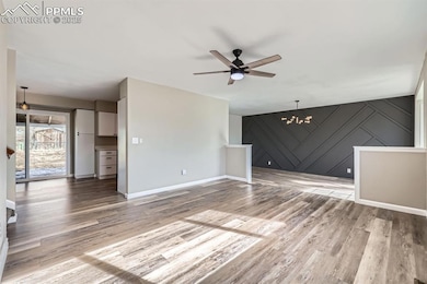 Unfurnished living room with ceiling fan with nota