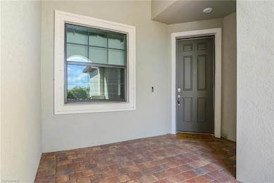 Entrance to property featuring stucco siding and a patio area