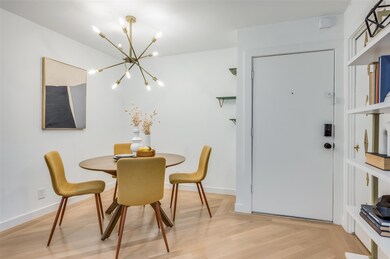 Dining room featuring light hardwood / wood-style flooring and an inviting chandelier