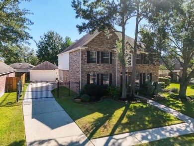 Experience the privacy and ease of a long driveway that runs alongside the home to the garage, featuring an automatic gate for added security.
