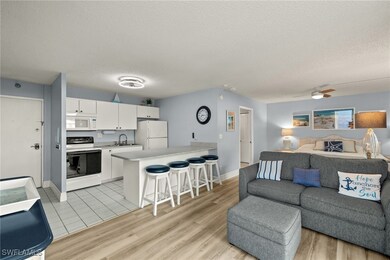 Kitchen featuring white appliances, white cabinets