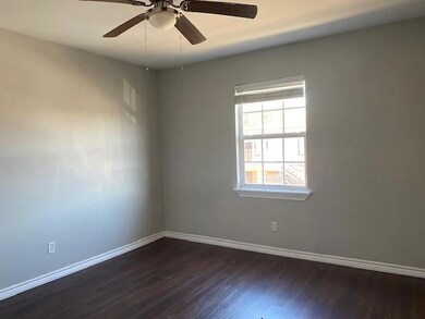 Empty room featuring dark hardwood / wood-style floors and ceiling fan