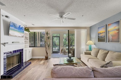 Living room with wood burning fireplace opens to lanai