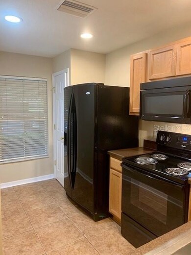 To the left of the refrigerator is a closet pantry