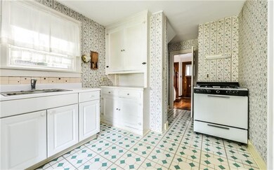 Bright kitchen includes newer refrigerator and gas