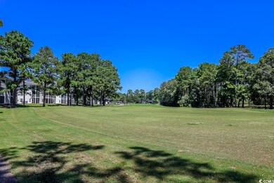 Surrounding community with a lawn and view of scattered trees