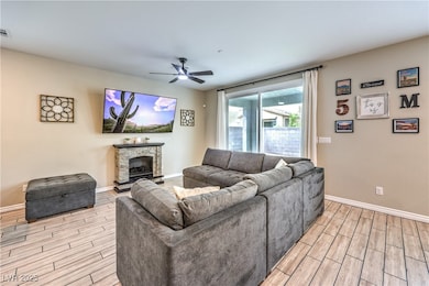 Living area with wood finish floors, a ceiling fan