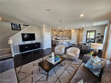 Living area with dark wood-type flooring, baseboar