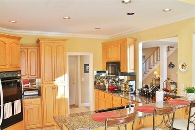 Beautiful kitchen with plenty of custom cabinets, counter space and a pull up wet bar!