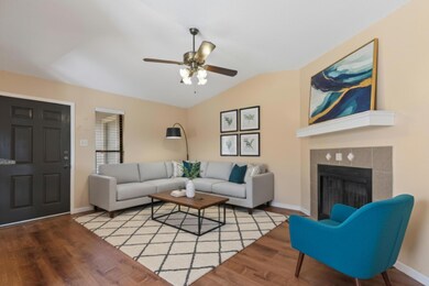 Living area with wood finished floors, lofted cei